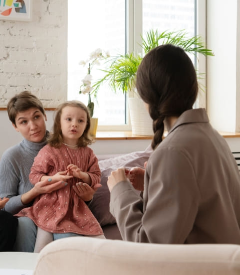 A girl child sitting with developmental pediatricians for autism diagnostic assessment  in Mississauga center.